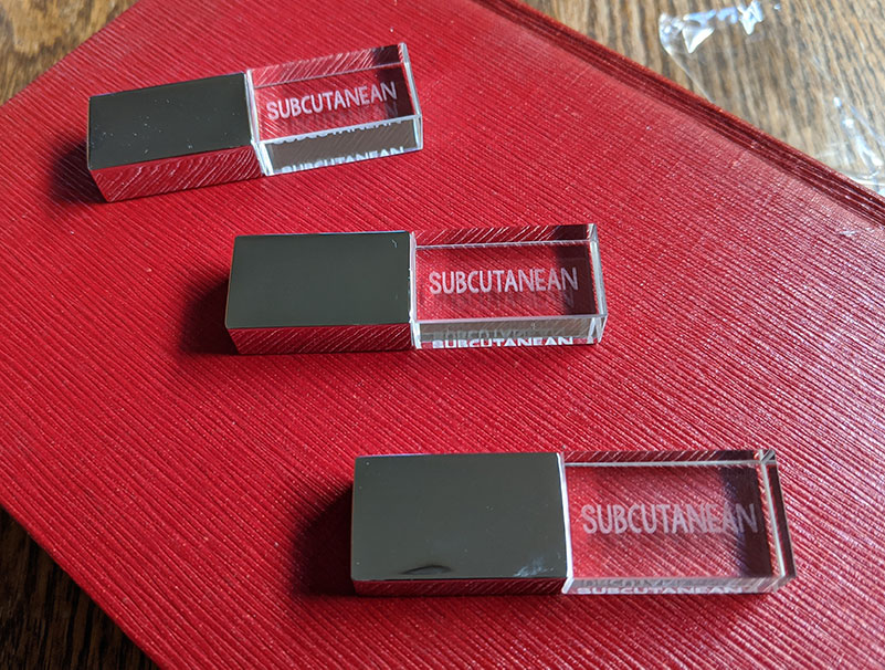 The original Subcutanean USB keys, long sold-out. Part of the novel involves the contents of the novel being discovered on a dimension-jumping USB key, so these were satisfyingly meta.